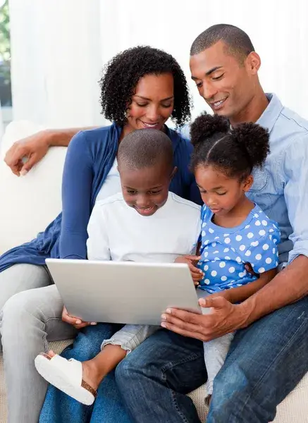 depositphotos 10293057 stock photo happy family using a laptop